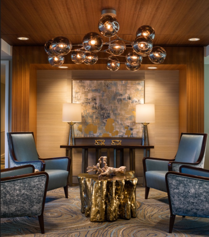 Four blue chairs around a golden table